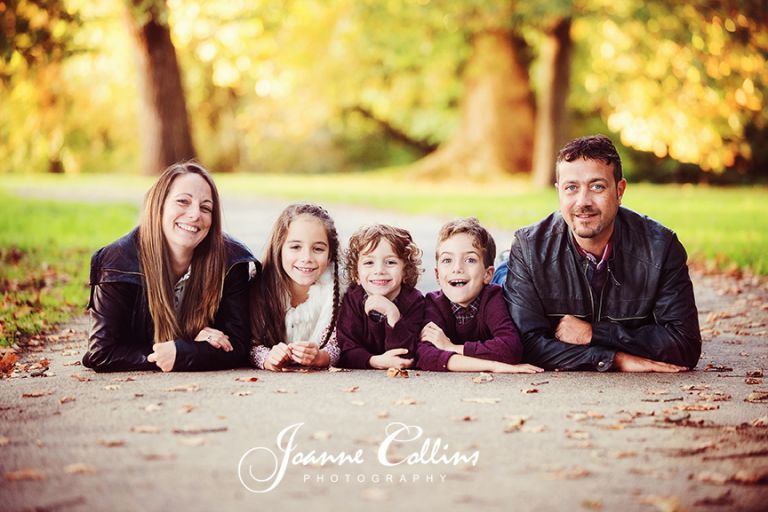 on-location family photography mote park maidstone kent family posing together on path