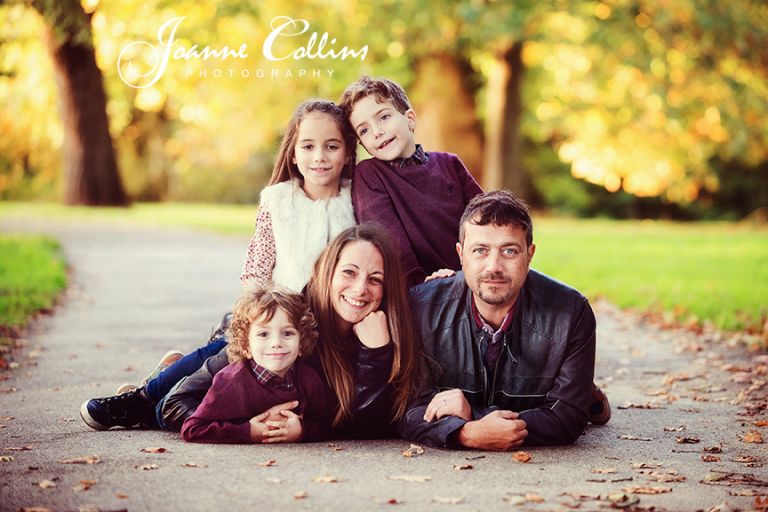 on-location family photography mote park maidstone kent family posing together on path