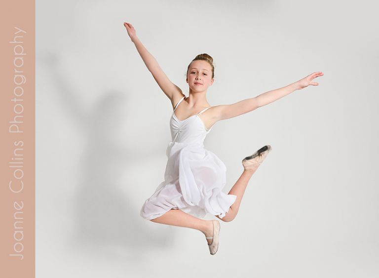 studio photographer kent dance model portfolio young teen in ballet dress performing a dance jump